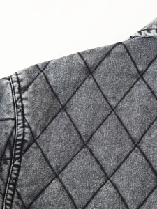 Detail showing stone washed denim jacket with diamond quilted pattern and gray finish