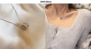 Close-up of sparkling cubic zirconia paved cylinder pendant on silk fabric and model neck