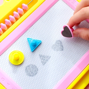 Pink magnetic drawing board for kids with colorful stamps and yellow abacus beads