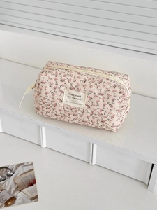 Detail of pink floral corduroy cosmetic bag with high-quality zipper and woven label