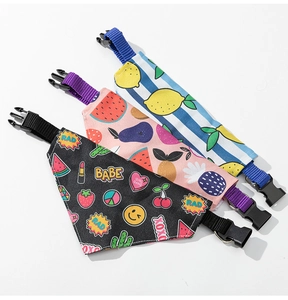 Detailed view of three assorted dog bandanas with lemon, tropical, and sticker prints