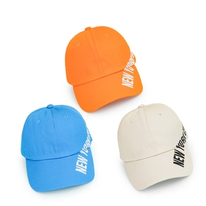 Three cotton baseball caps in orange, sky blue, and beige with New York City embroidery