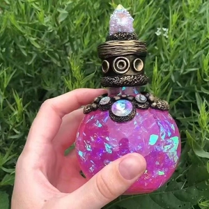 Magic potion bottle with pink liquid and crystal stopper for garden decoration