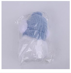 Blue knit Christmas hat with plush ear muffs in transparent gift packaging bag