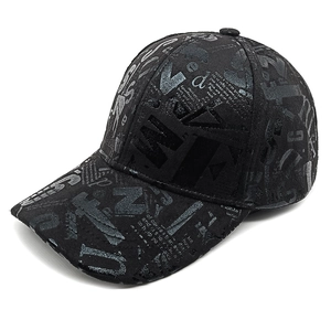 Close-up of black baseball cap with all-over vintage graffiti letter print and curved brim