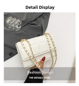 Detail shot of a white quilted crossbody bag with golden chain strap and leather weave