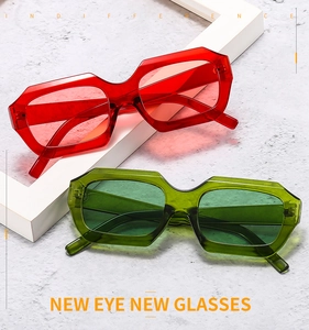 Close-up of trendy geometric red and green sunglasses with thick translucent resin frames
