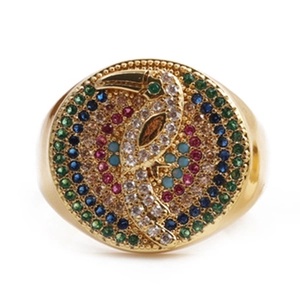 Exaggerated gold open ring featuring a colorful zircon toucan bird on a circular face