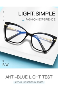 Detailed close-up of retro cat-eye glasses with golden metal temples on a geometric stand