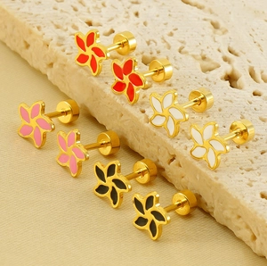 Detail of floral enamel stud earrings in gold with colorful petal variety and screw backs