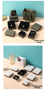 Detail of pink and white jewelry gift boxes with gold lettering and matching paper bags