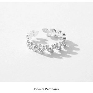 Macro detail of S925 sterling silver leaf ring with sparkling zircon stone accents