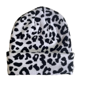 Close-up of black and white leopard print knit beanie with folded cuff detail