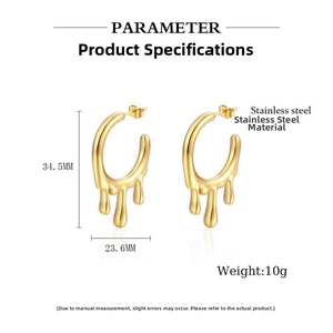 Macro detail of golden irregular fluid teardrop earrings in polished stainless steel