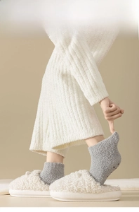 Detail of high-count yarn coral fleece socks with fine twisted knit texture for durability