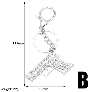 Detailed view of rhinestone pistol keychain with dimensions 115mm by 35mm and 22g weight