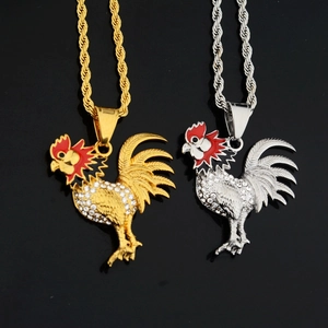 Detailed close-up of rooster zodiac pendant in gold and silver with white sparkling crystals