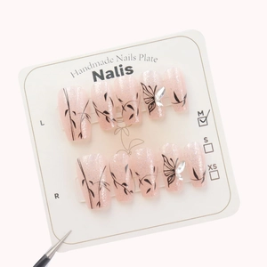 Pink glitter press-on nails with black butterfly and bamboo patterns with 3D crystals