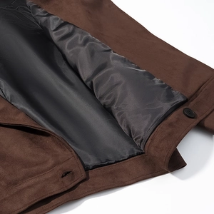 Detail shot of brown faux suede jacket featuring black buttons and smooth inner lining