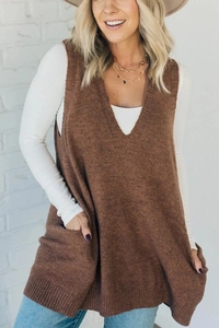 Close-up of brown V-neck knit vest texture with functional front pockets on a model