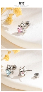 Detailed view of screw-back cat earrings with pink and blue heart-shaped cubic zirconia