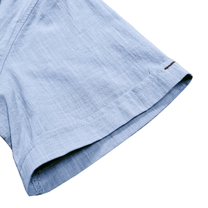 Detailed close-up of blue linen-blend short sleeve cuff with premium stitching