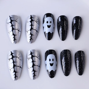 Halloween almond press-on nails with white ghost and black crackle patterns
