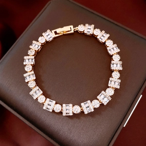 Detail of 18k gold plated bracelet featuring rectangular and round zircon inlay