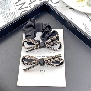 Elegant black satin scrunchie and hair clip set with sparkling rhinestone bows
