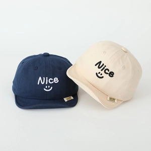 Kids' cotton baseball cap with 'Nice' smiley embroidery in navy blue and cream white colors