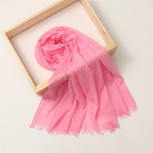 Detail of pink cotton linen scarf with soft fringe texture in a wooden frame box