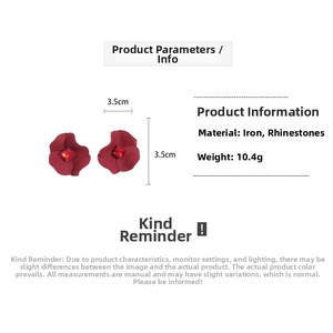 Detail view of red flower earrings with rhinestone center showing size 3.5cm and 10.4g weight