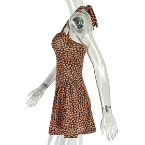 Detail of floral printed halter neck swim dress with pleated A-line skirt and open back
