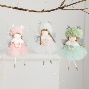 Close-up of three angel deer girl plush ornaments with tulle skirts on a festive branch