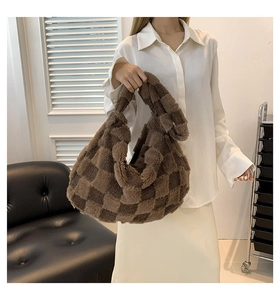 Detail of plush tote bag featuring a dark brown checkerboard pattern and soft texture
