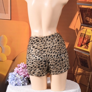 Detailed view of sequined leopard print tweed shorts with sparkling texture and finish