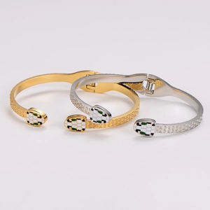 Snake head stainless steel spring bracelet in gold and silver finish with enamel detail