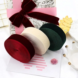 Velvet ribbon rolls in burgundy, off-white, and dark green for gift wrapping and DIY bows