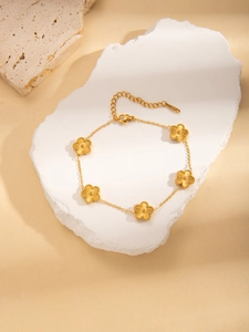 Close-up of gold-plated stainless steel floral bracelet with five detailed petals