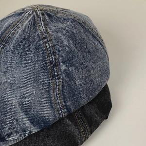Washed denim newsboy caps in blue and black with vintage yellow stitching details