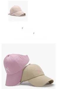 Detail showing bow embroidery on pastel baseball caps in pink, purple and khaki