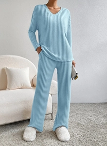 Detail of light blue ribbed knit loungewear set featuring V-neck top and wide-leg trousers