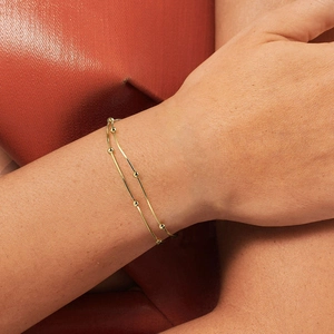 Elegant double-layered S925 sterling silver chain bracelet with beads on gold finish