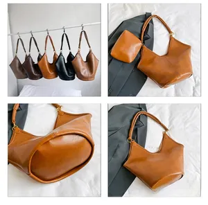 Detail view of large vintage shoulder bags in five colors with textured PU leather finish
