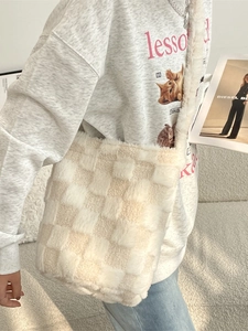 Fuzzy checkerboard faux fur crossbody bucket bag with beige and brown plush texture