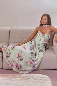 Elegant floral mint green dress with purple roses shown on a model lying on a sofa