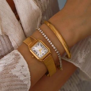 Close-up of a 18K gold plated stainless steel watch and bracelet set on a model wrist