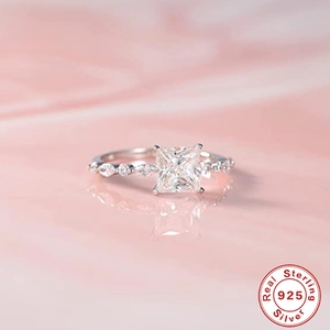 Macro shot of 925 sterling silver ring with square diamond and marble background