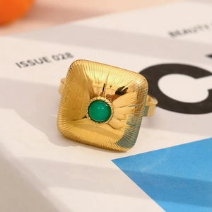 Detailed macro view of 18K gold plated vintage ring featuring a round green gemstone