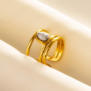 Detail of bohemian gold layered ring with hand-hammered texture and teardrop stone